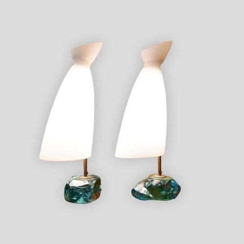 A pair of table lamps, with brass structure on cut glass pedestals with white satin blown glass shades designed by Roberto Giulio Rida