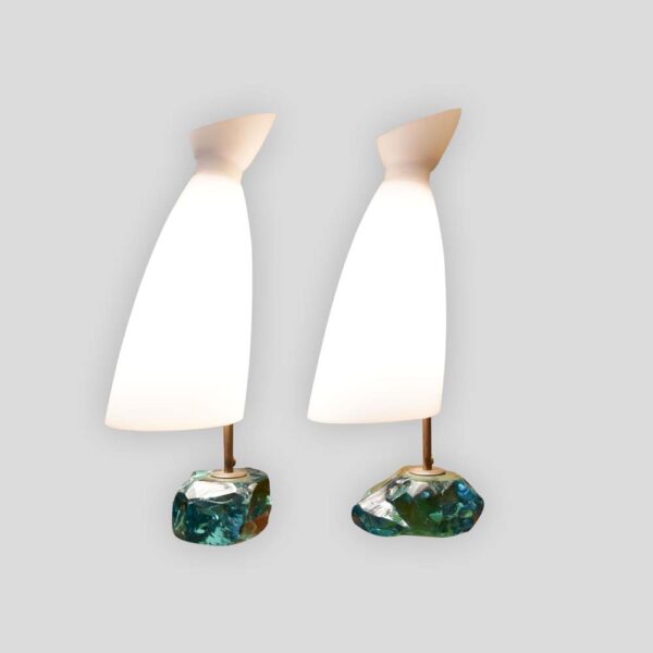 A pair of table lamps, with brass structure on cut glass pedestals with white satin blown glass shades designed by Roberto Giulio Rida