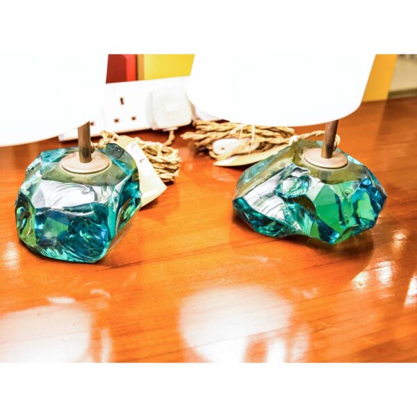 A pair of table lamps, with brass structure on cut glass pedestals with white satin blown glass shades designed by Roberto Giulio Rida