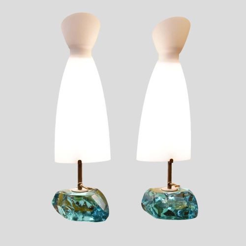 A pair of table lamps, with brass structure on cut glass pedestals with white satin blown glass shades designed by Roberto Giulio Rida