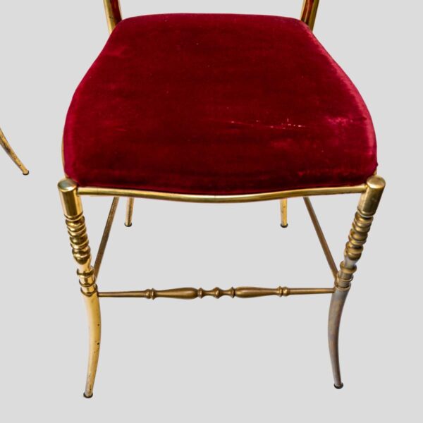 Red velvet upholstered brass metal chairs by Chiavari